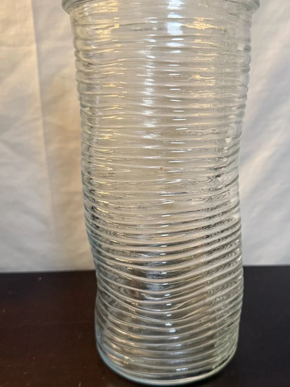 Ribbed glass vase, wavy, pinched shape. Mid-Century Modern design. 9.75”